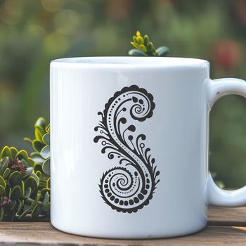 An ornate paisley shape with intricate details, suitable for use in various designs.