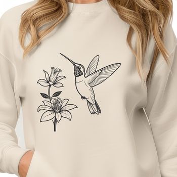 A colorful hummingbird in mid-air, surrounded by floral elements.