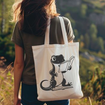 An illustration of a salamander holding a book and sitting on a stack of books.