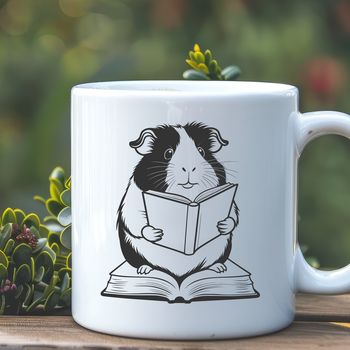 An anthropomorphic guinea pig character holding a book in its front paws, symbolizing education and literacy.