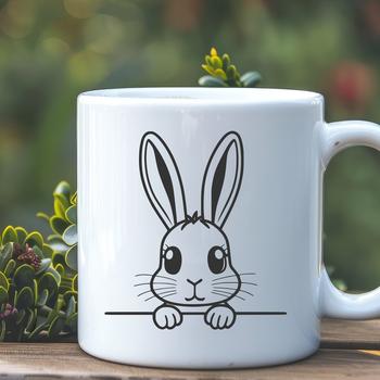 A cute cartoon rabbit peeking out from behind a leaf with bright green grass in the background.