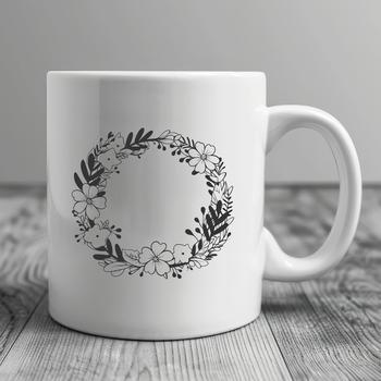 A floral design made from interconnected leaves and flowers, forming a circular wreath shape.