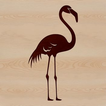 A colorful flamingo standing in shallow water, its long neck bent as it searches for food.