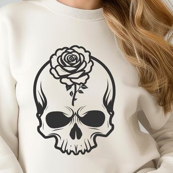 A gothic-inspired skull design with intricate details and a floral motif featuring roses.