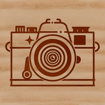 A stylized illustration of a camera with lens and shutter.