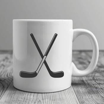 A graphic illustration of a hockey stick and puck, created as a vector design.