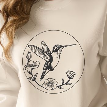 A colorful hummingbird in flight over a floral arrangement.