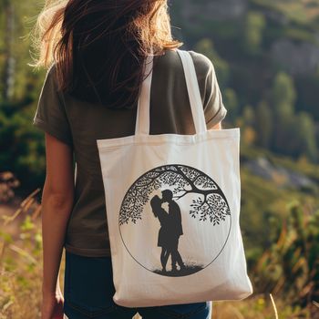 A pair of embracing silhouettes under a blooming tree branch with intertwined leaves.