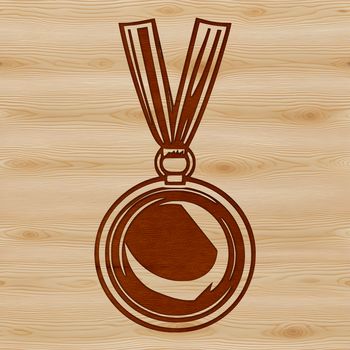 A gold-colored medal with a ribbon and a small engraving on the front.