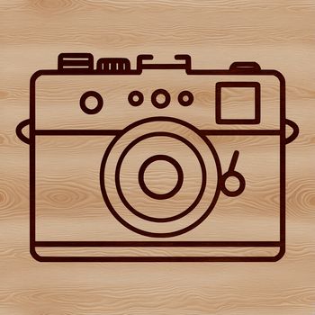 A simple line drawing of a digital camera with lens and body.