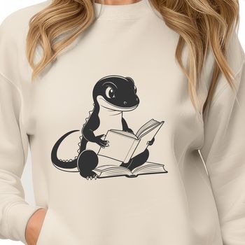 A digital illustration of a salamander holding a book in its front legs.