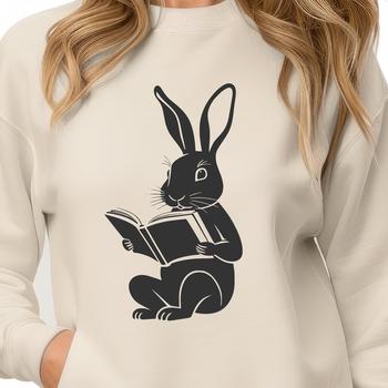 A cute rabbit sitting on its haunches, holding a book in front of it.