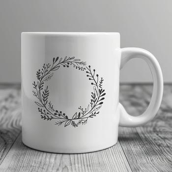 A floral design featuring a circular wreath with various flowers and foliage.