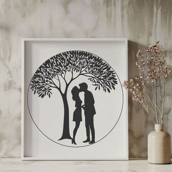 A pair of lovers embracing under the branches of a tree.