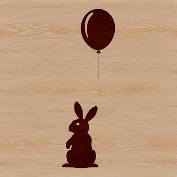 A cartoon-style illustration of a sitting rabbit holding a balloon.