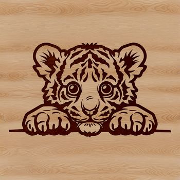 A cute tiger's head peeking out from behind foliage.