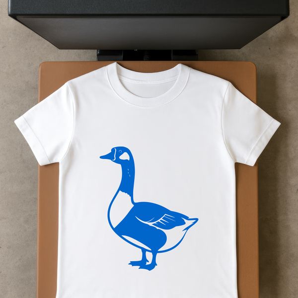 A single white goose standing on green grass with its wings spread.