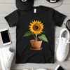 Bright Yellow Sunflower in Ceramic Pot A large, bright yellow sunflower standing tall in a ceramic flower pot with green leaves and stem.