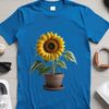 Bright Yellow Flower in Container A single sunflower stands tall in a flower pot, with its bright yellow petals and dark center.