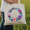 A floral wreath made from various colorful flowers and foliage elements.