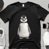 Cute Baby Penguin in Transparent Background A small penguin chick standing on a flat surface with a transparent background.