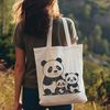 Playful Panda in the Wild A cuddly panda bear in its natural habitat.