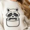 Adorable raccoon peeking out from a pocket. A raccoon peeking out from a pocket.