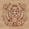 A winged angel figurine amidst floral patterns.