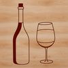 A bottle of wine sitting on a table next to a glass.