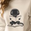 Whimsical Amphibian Reading Nook A salamander in a thoughtful pose, sitting on a book with its mouth open as if reading.