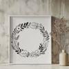 Interconnected floral motif in a circular shape A floral design consisting of intertwined stems and leaves forming a circular shape.