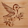 An ornate illustration of a hummingbird perched on a stylized floral branch, detailed for cutting or digital use.
