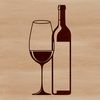 Wine bottle sitting on a table with a glass beside it.
