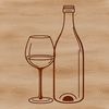 A bottle of wine sitting on a wooden table with a glass next to it.