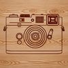 Free Photography Icon SVG A digital camera with a lens and shutter button, depicted in vector form for easy editing and customization.