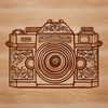 Close-up illustration of an ornate camera lens with photography equipment in the background.