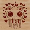A smiling monster with love hearts on its face.
