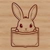 Adorable Rabbit Peeking from Pouch Close-up image of a rabbit's head peeking out from behind a pocket or pouch.