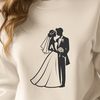 Free SVG Wedding Clip Art A stylized illustration of a bride and groom standing together, surrounded by flowers and foliage.