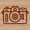 A simple line drawing of a camera for photography enthusiasts and designers.