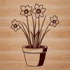 Spring Blooming Daffodil in Ceramic Pot A yellow daffodil flower growing in a small ceramic pot on a table or desk.