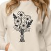 A stylized floral arrangement featuring a collection of flowers tied together with a ribbon.
