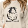 SVG Vector Graphic Guinea Pig Design A cartoon guinea pig holding a book in its paws, ideal for clip art designs.