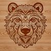 An ornate graphic representation of a wild animal featuring a stylized bear's head with decorative elements.