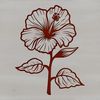 A colorful floral design featuring a large hibiscus flower with long stems and leaves.