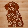 Floral Accent with Cute White Breed A white Havanese dog sitting in front of a floral arrangement.