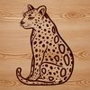 Close-up of a wild ocelot sitting on the forest floor.