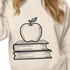 Teacher's Desk Decoration A digital illustration of an apple book with a teacher's desk in the background.