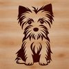 A small breed dog, specifically a Yorkshire Terrier, depicted in a sitting position.