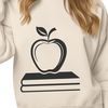 Educational Icon with Apple Logo A teacher's desk with an open book featuring the apple logo on the cover, suitable for educational settings.